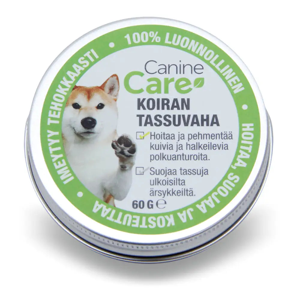 Pyöreä hopeinen metallitinssi jossa on 60g caninecare tassuvaha koiran tassuvoide vihreällä ja valkoisella etiketillä shiba inu kuvalla