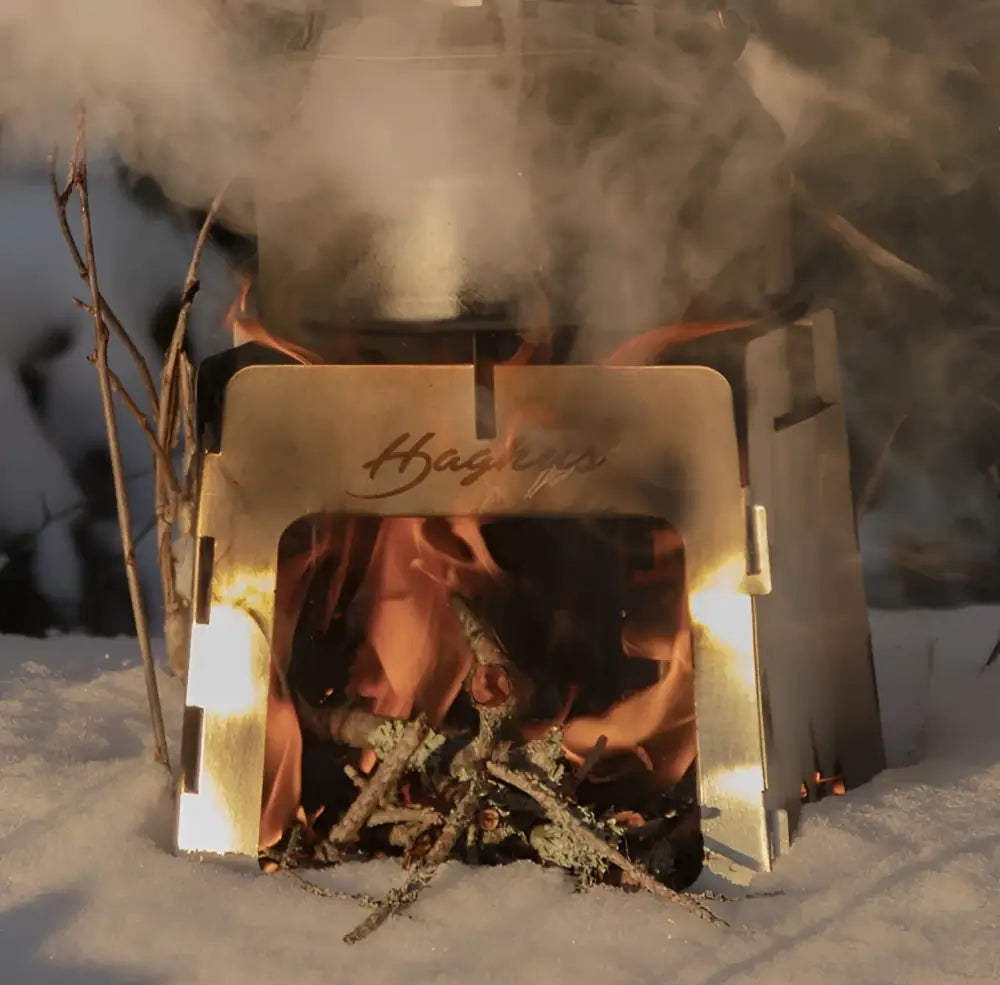 A sleek metallic hågrips portable fire pit with engraved branding from haghus iso risukeitin collection
