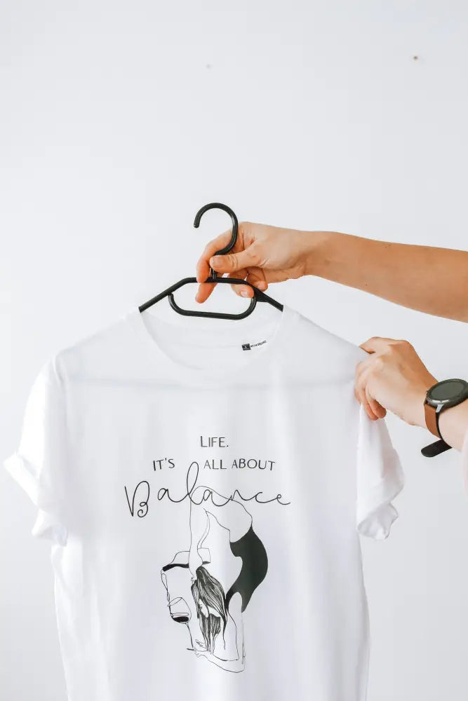 White cotton t-shirt with black graphic of a woman in a yoga pose and the text life from it’s all about balance t-shirt