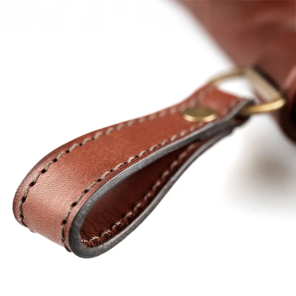 Brown leather keychain with contrasting dark stitching and brass-colored metal clasp for karhun kynsiveitsi hopeisella holkilla uhc