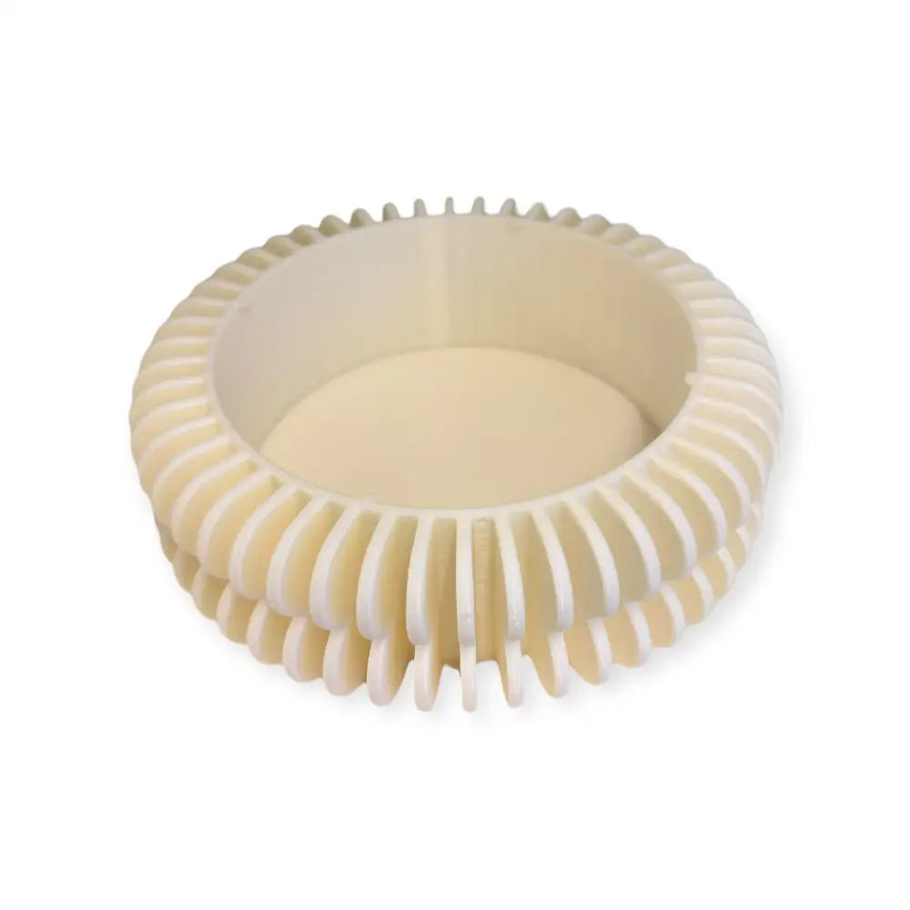 Cream-colored ribbed plastic bowl with circular fluted design for kukkaruukun alunen use