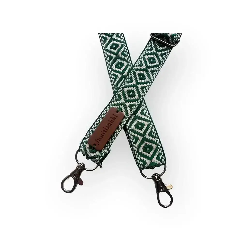 Laukun olkahihna with green and white geometric pattern woven strap metal clasps and brown leather tag