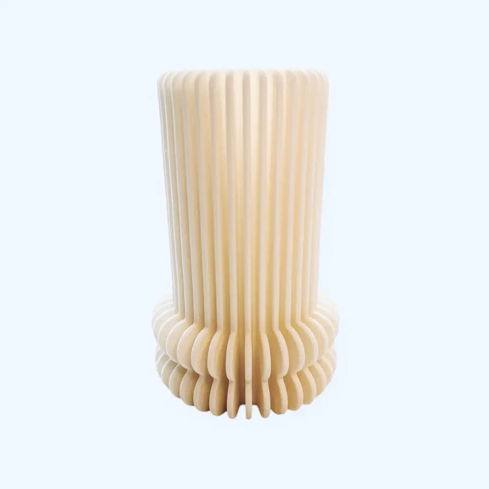 Cream-colored maljakko with ribbed cylindrical shape, vertical grooves, and a fluted base for elegant decoration
