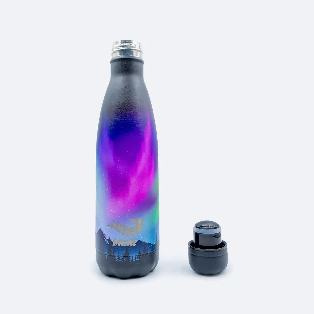 A sleek insulated 500 ml meribottles aurora borealis water bottle with a vibrant purple and blue gradient design over dark gray