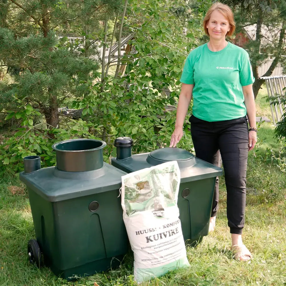 Vihreä muovinen paketti green toilet 120 family kompostikäymälä mustalla kannella ja sivuputkilla nähdä takaa