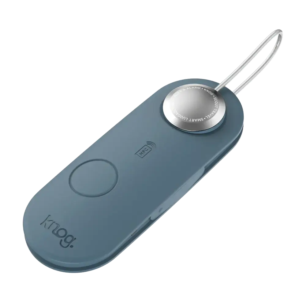 A sleek matte blue Scout travel light with a silver button and thin white cord by Knog smart Luce