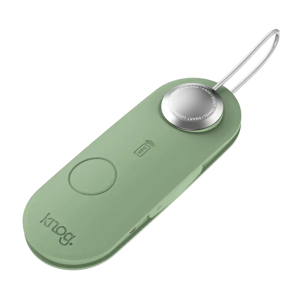 Mintin vihreä knog scout travel green älykäs matkatavaramerkki hopeisella pyöreällä napilla ja metallisilmukalla