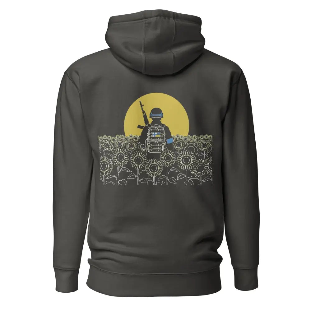 Dark gray hooded sweatshirt with a graphic of a soldier in a sunflower field and yellow circular backdrop stand with ukraine huppari